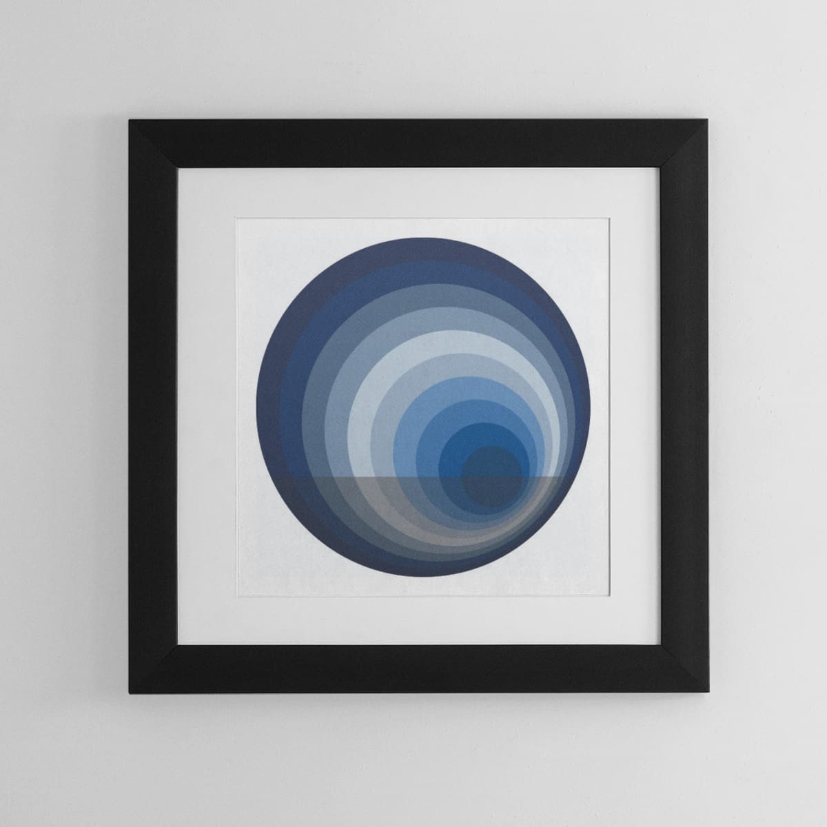 Abstract framed wall art comprised of circles in complementery shades of blue