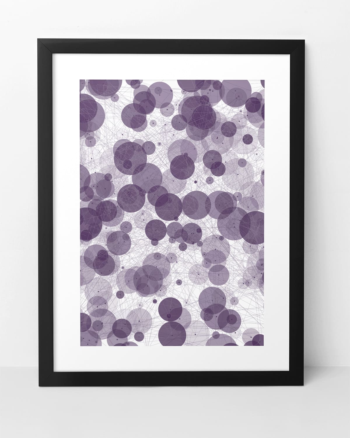 Framed abstract artwork comprised of circles and lines, representing sonder.